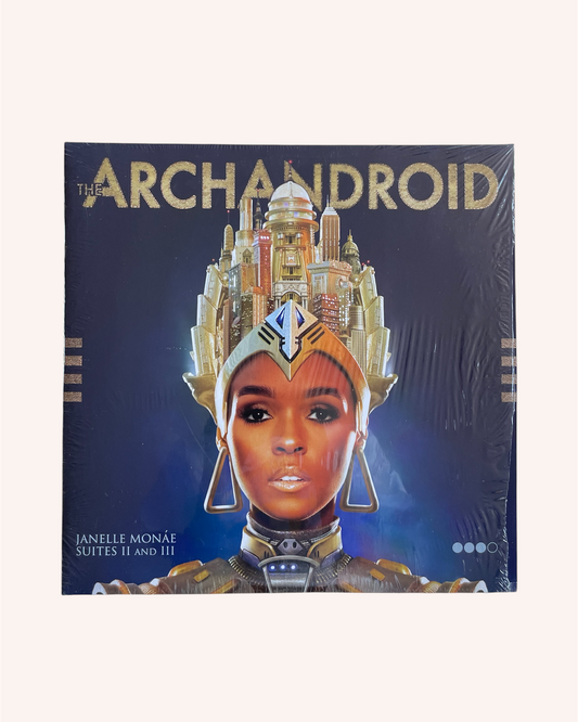Album cover for 'The Archandroid' featuring a person in futuristic attire with a cityscape background. The ArchAndroid - Janelle Monae