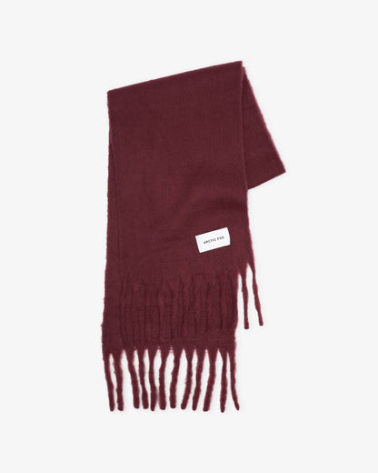 Maroon scarf with fringes on a light gray background