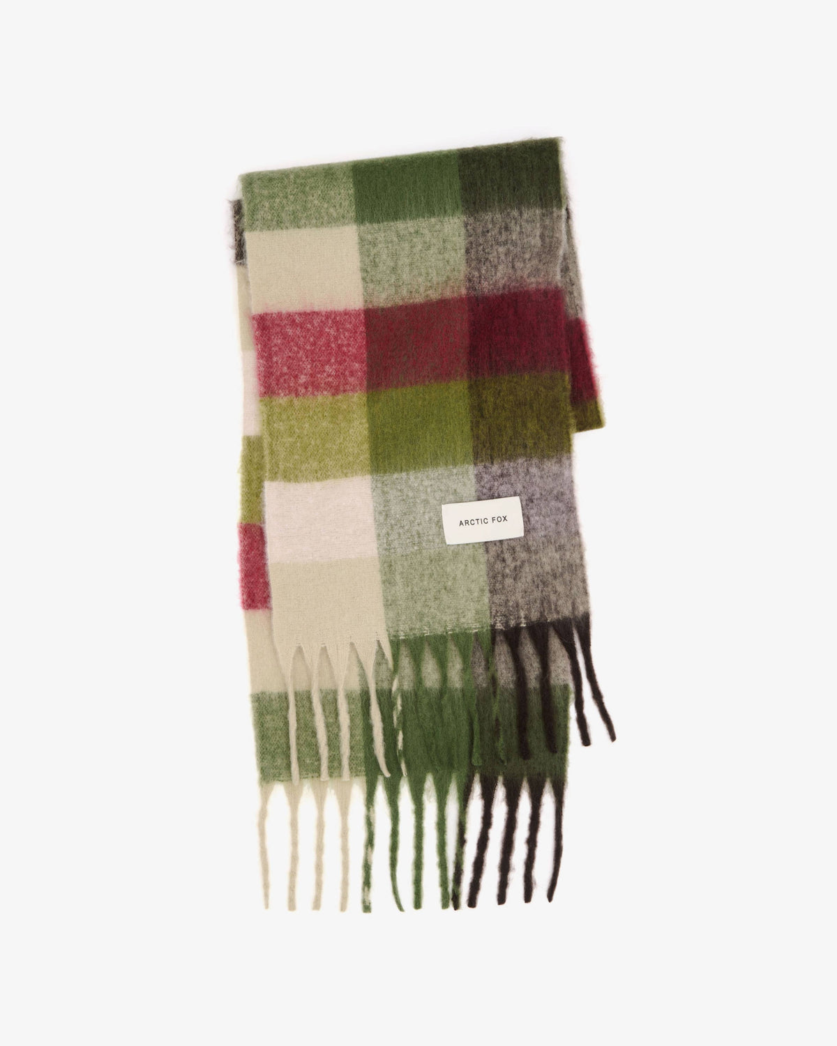 A folded plaid scarf with fringe ends, featuring blocks of green, red, cream, and gray in a classic check pattern, with a small white label reading 'SARAH RICH'.