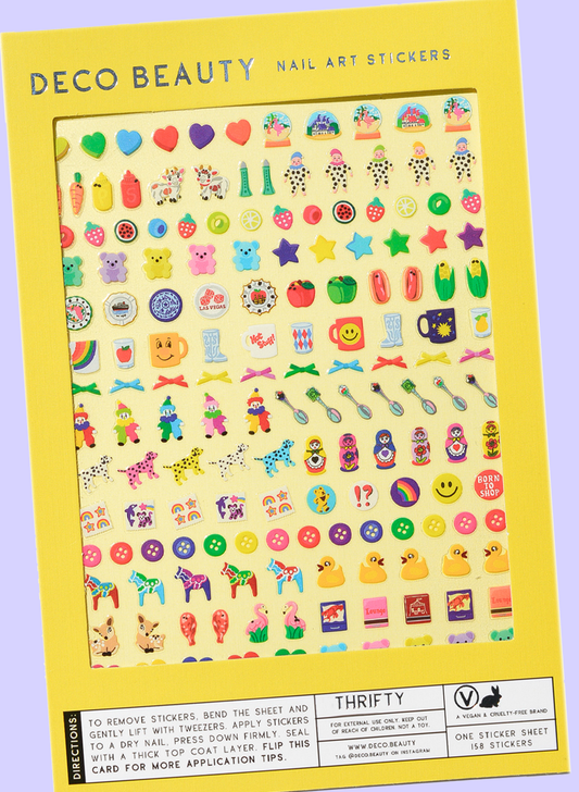 Sheet of colorful nail art stickers with various designs on a yellow card.