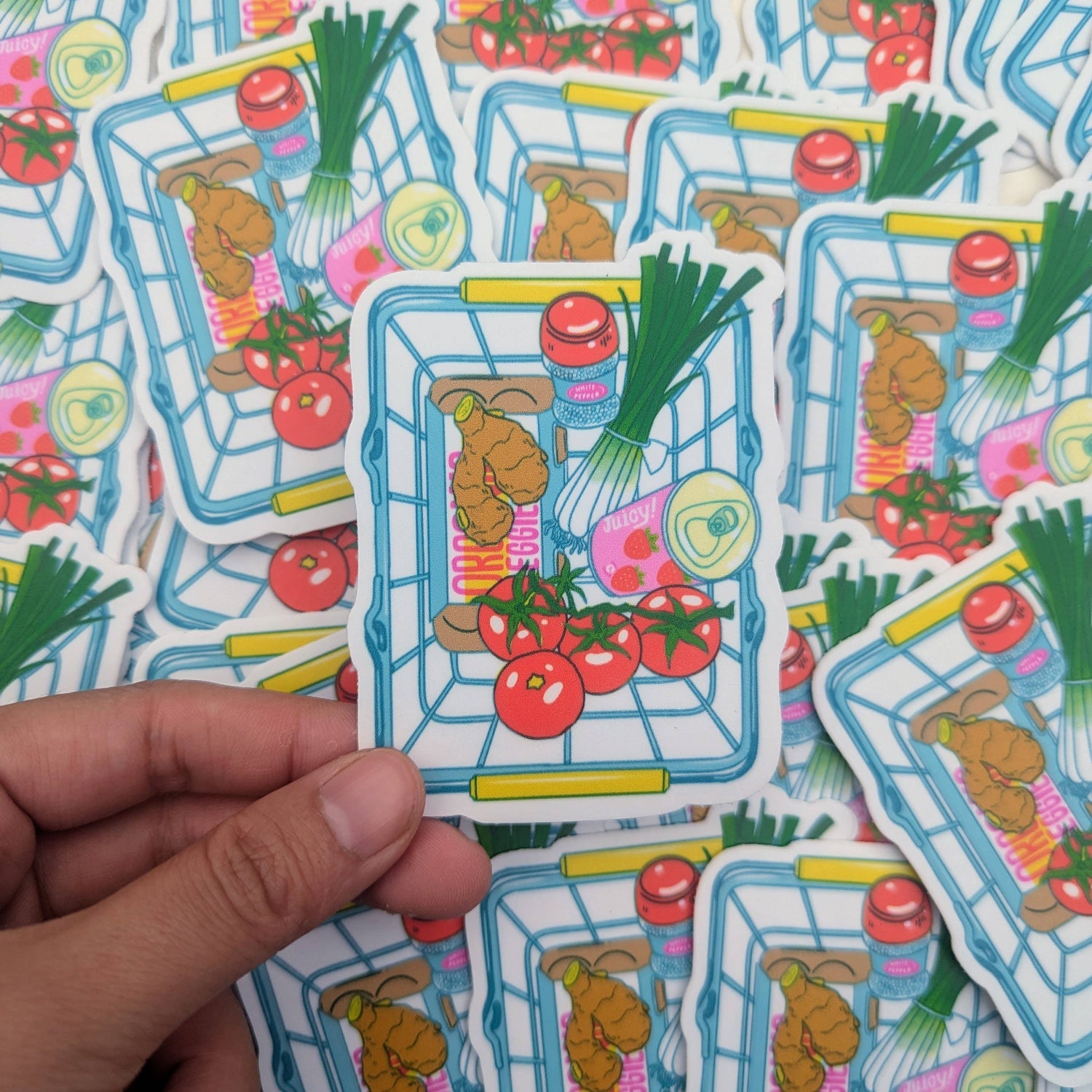 Colorful stickers of a shopping cart with groceries held by a hand, surrounded by more stickers.