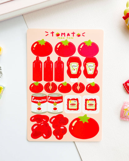 Sheet of tomato-themed stickers with ketchup bottles and other items on a light surface.