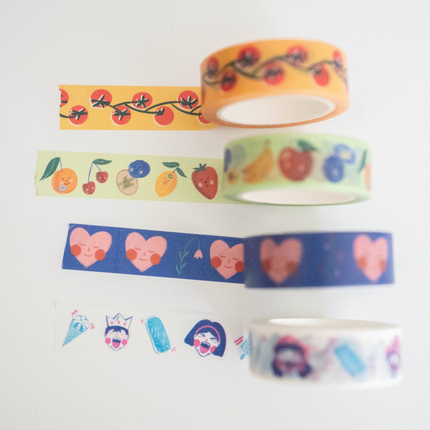 Set of colorful washi tapes with various designs on a white background