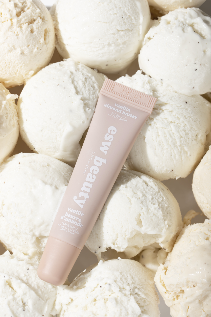 Pink tube of 'esw beauty' product surrounded by white bath bombs