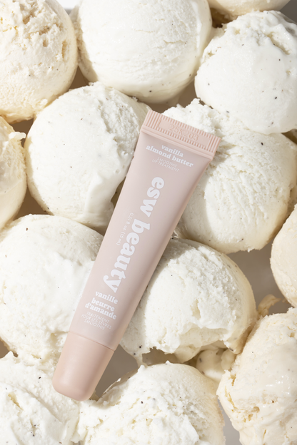 Pink tube of 'esw beauty' product surrounded by white bath bombs