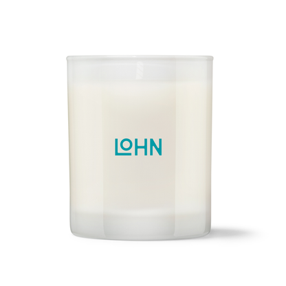 A frosted glass jar candle with white wax and a teal 'LOHN' logo printed on the front, set against a plain white background.