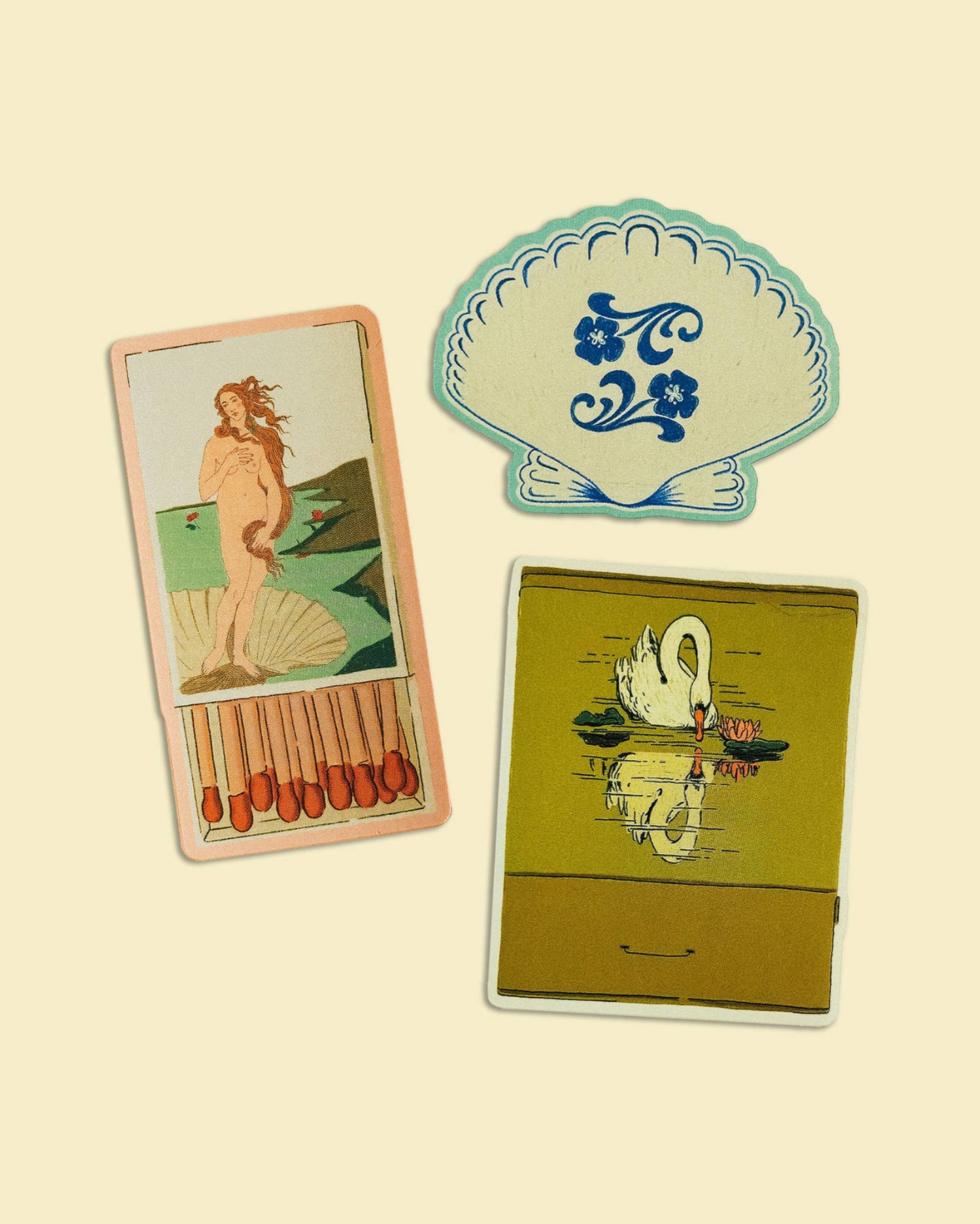 Three vintage-style cards with artistic designs on a beige background