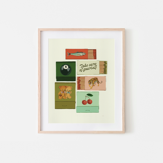 A framed art print featuring a retro-style illustration of vintage matchboxes with various designs, including a fish, an 8-ball, cherries, a tiger, and a teddy bear, displayed on a clean white background.