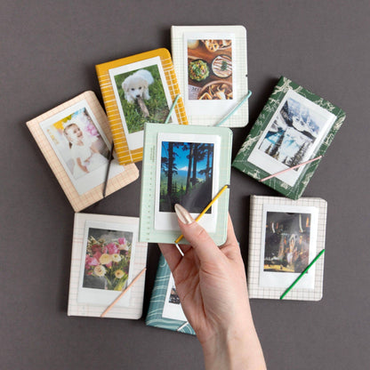 Collection of small photo frames with various images on a gray background
