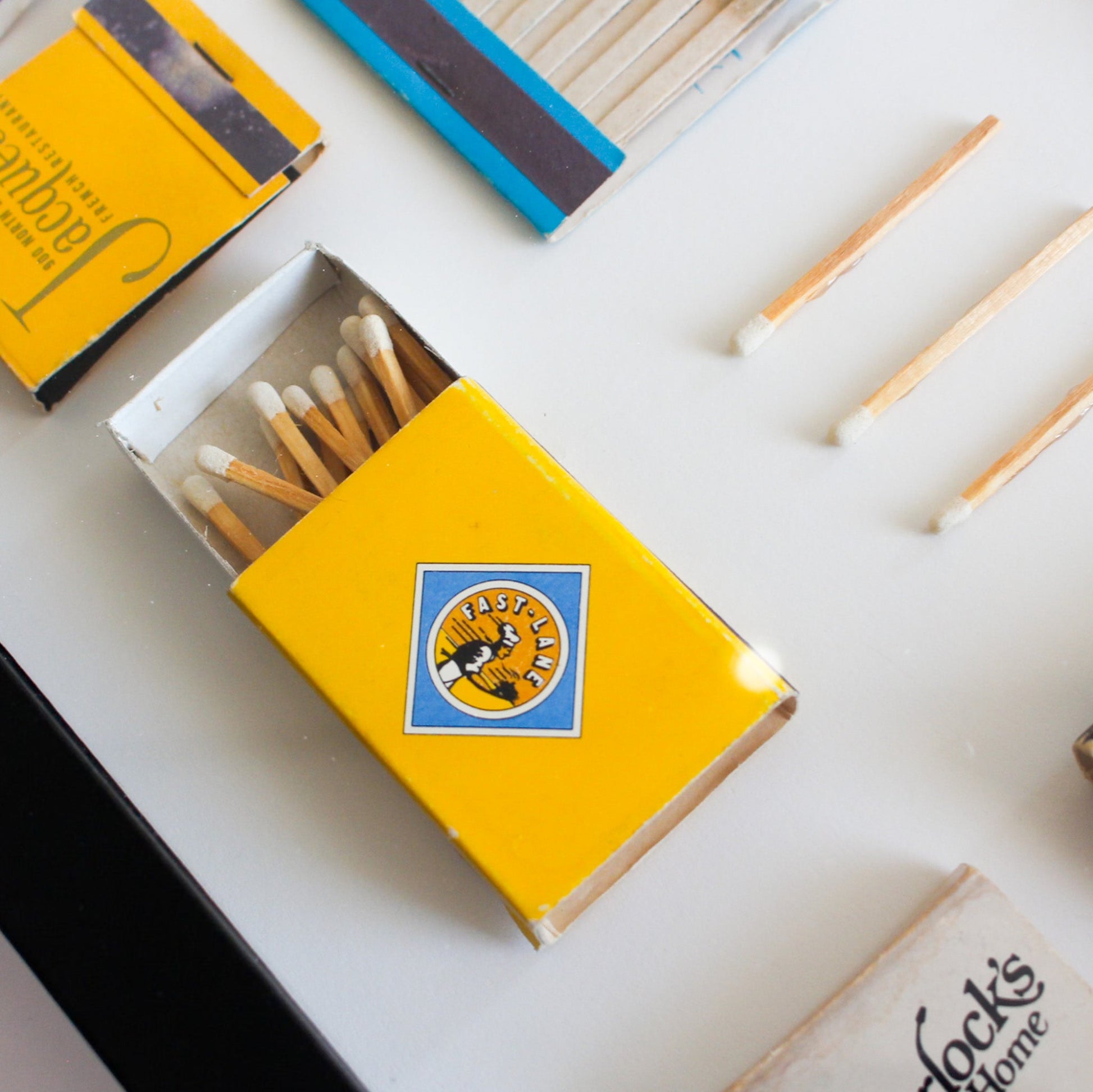 Yellow matchbox with matches spilling out on a light background