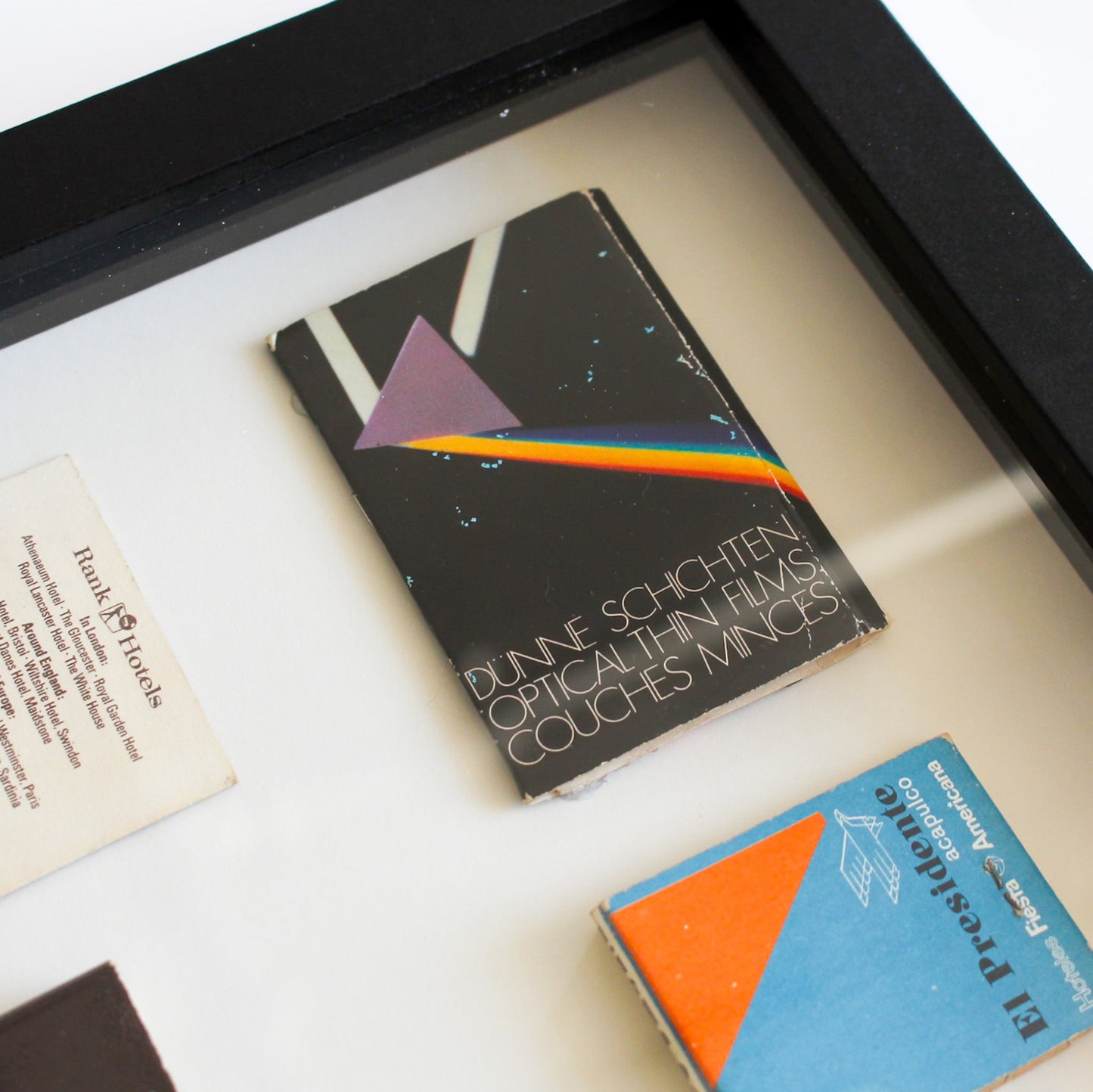 Framed book with a rainbow design on a white surface