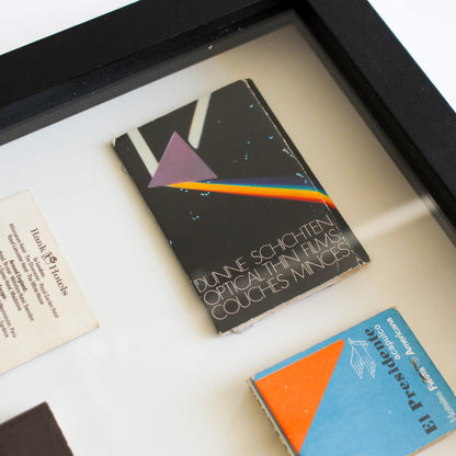 Framed book with a rainbow design on a white surface