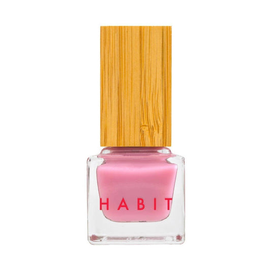 Pink nail polish bottle with wooden cap on a white background