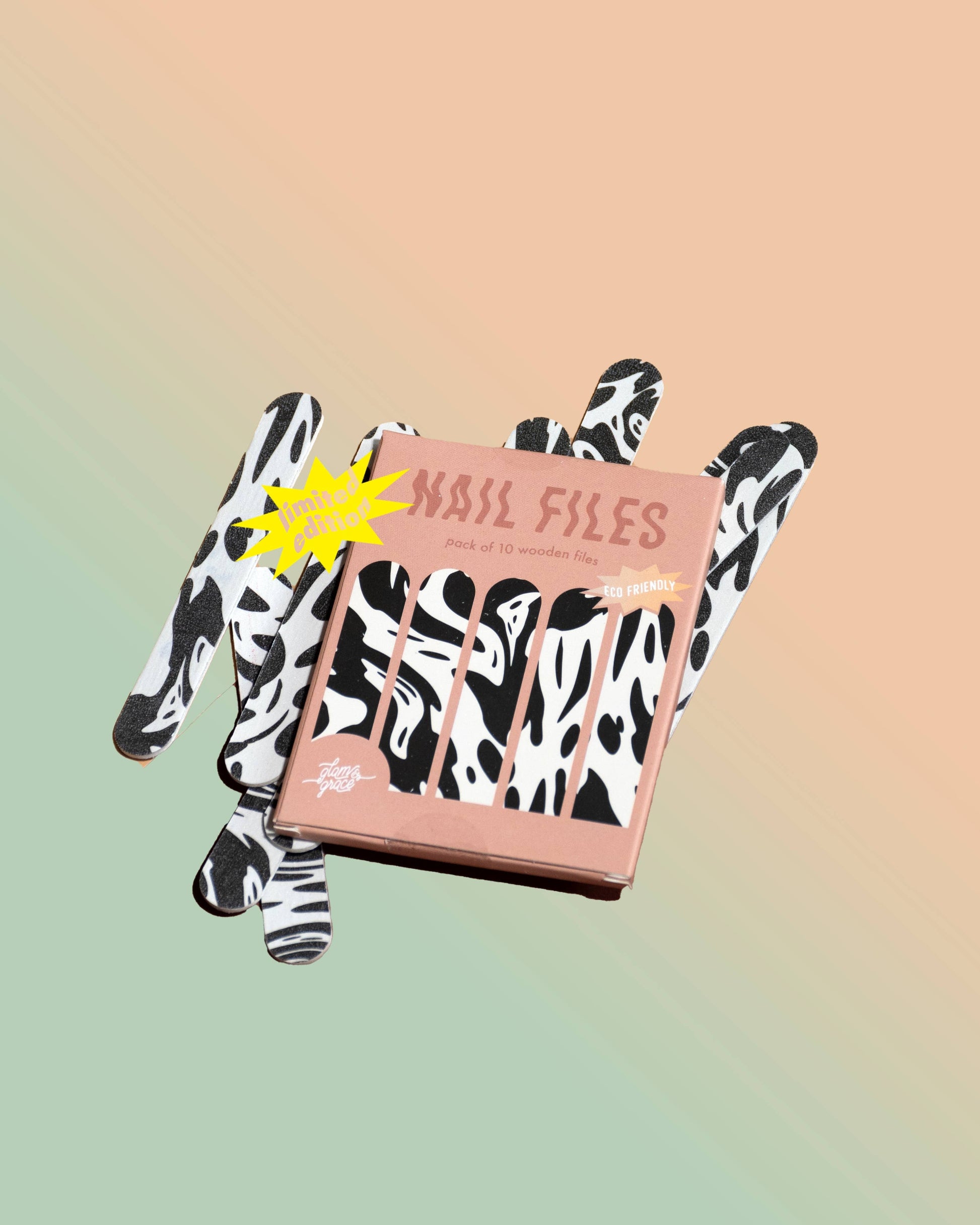 Box of nail files with cow print design on a gradient background