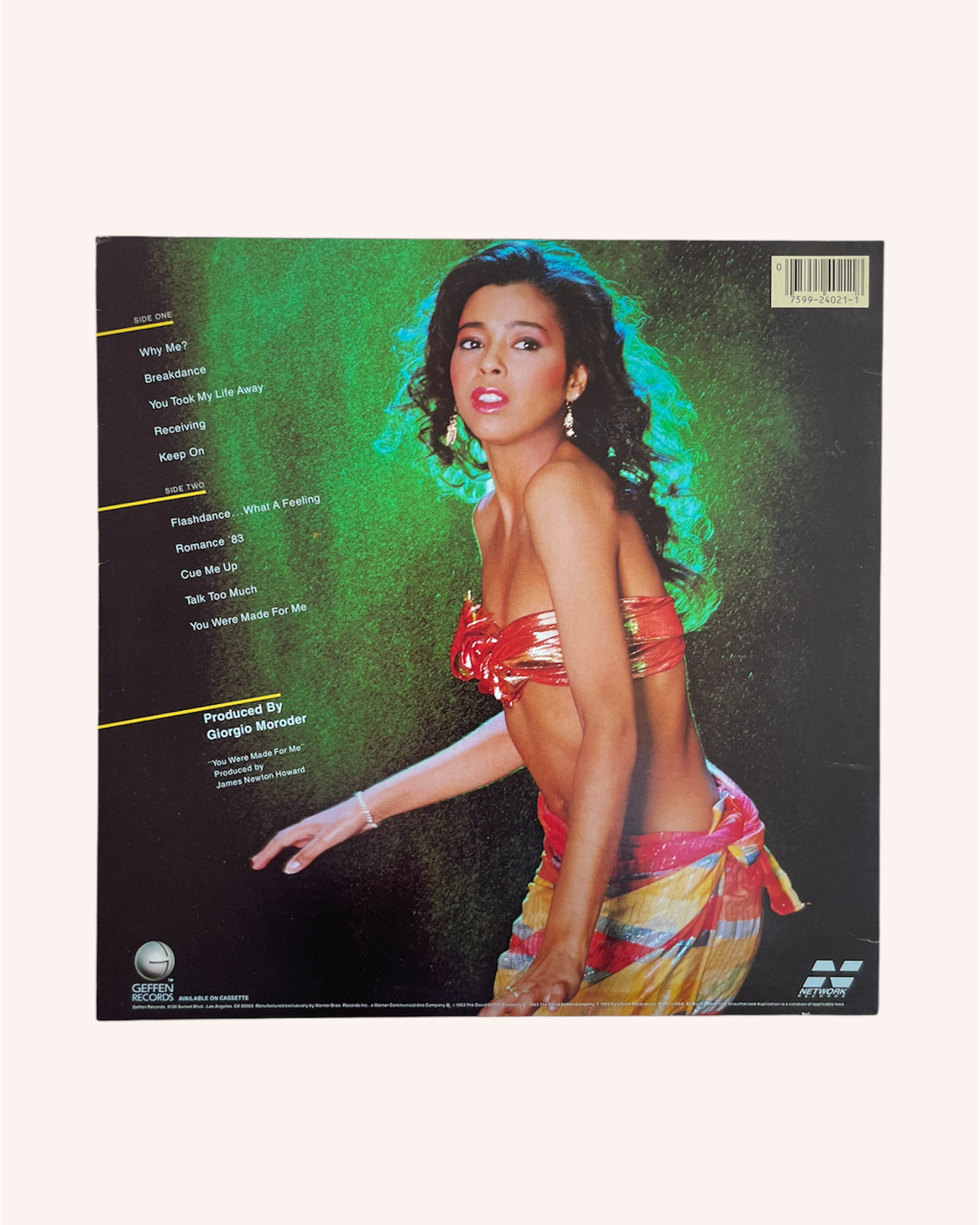 Vinyl record cover with a person in colorful attire on a green background, What a Feelin' Vinyl Record - Irene Cara