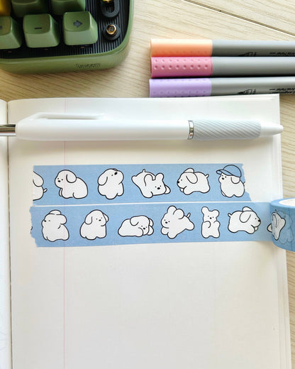 Notebook with cartoon dog designs on a desk with pens and a calculator. White Puppy Washi Tape