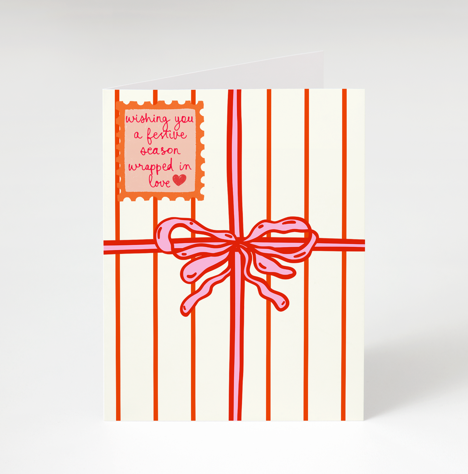 Card with red striped design and pink bow on a white background
