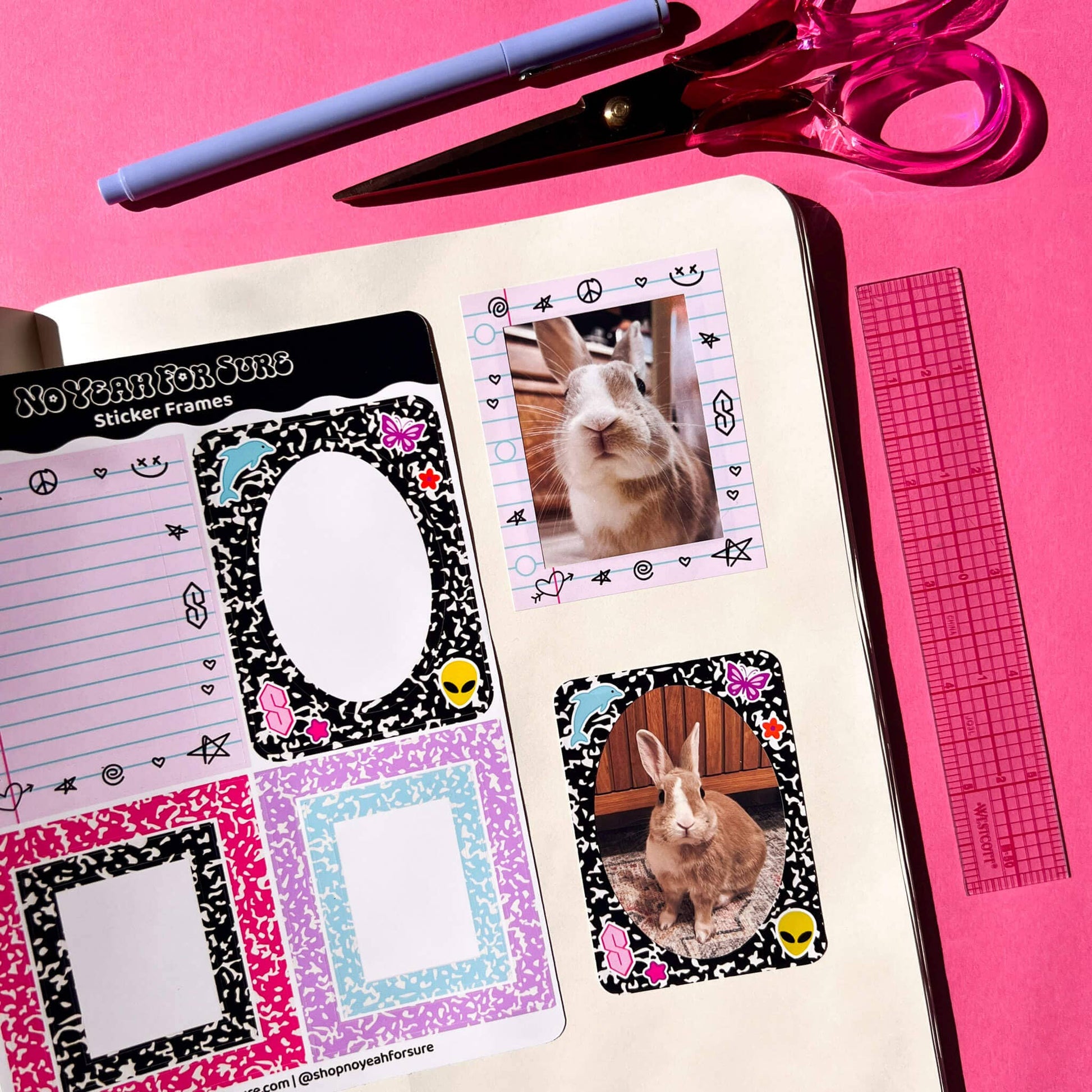 A styled flat-lay of a bullet journal planner page featuring Easter-themed stickers, including bunny photo inserts and patterned frames, with a pen, scissors, and ruler on a bright pink background.