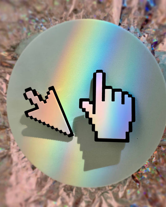 Two pixelated cursor icons on a round, iridescent object with a blurred background.