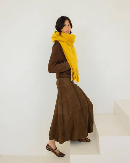 Woman wearing a brown outfit with a yellow scarf on a white background, Yellow Recycled Bottle Stockholm Scarf