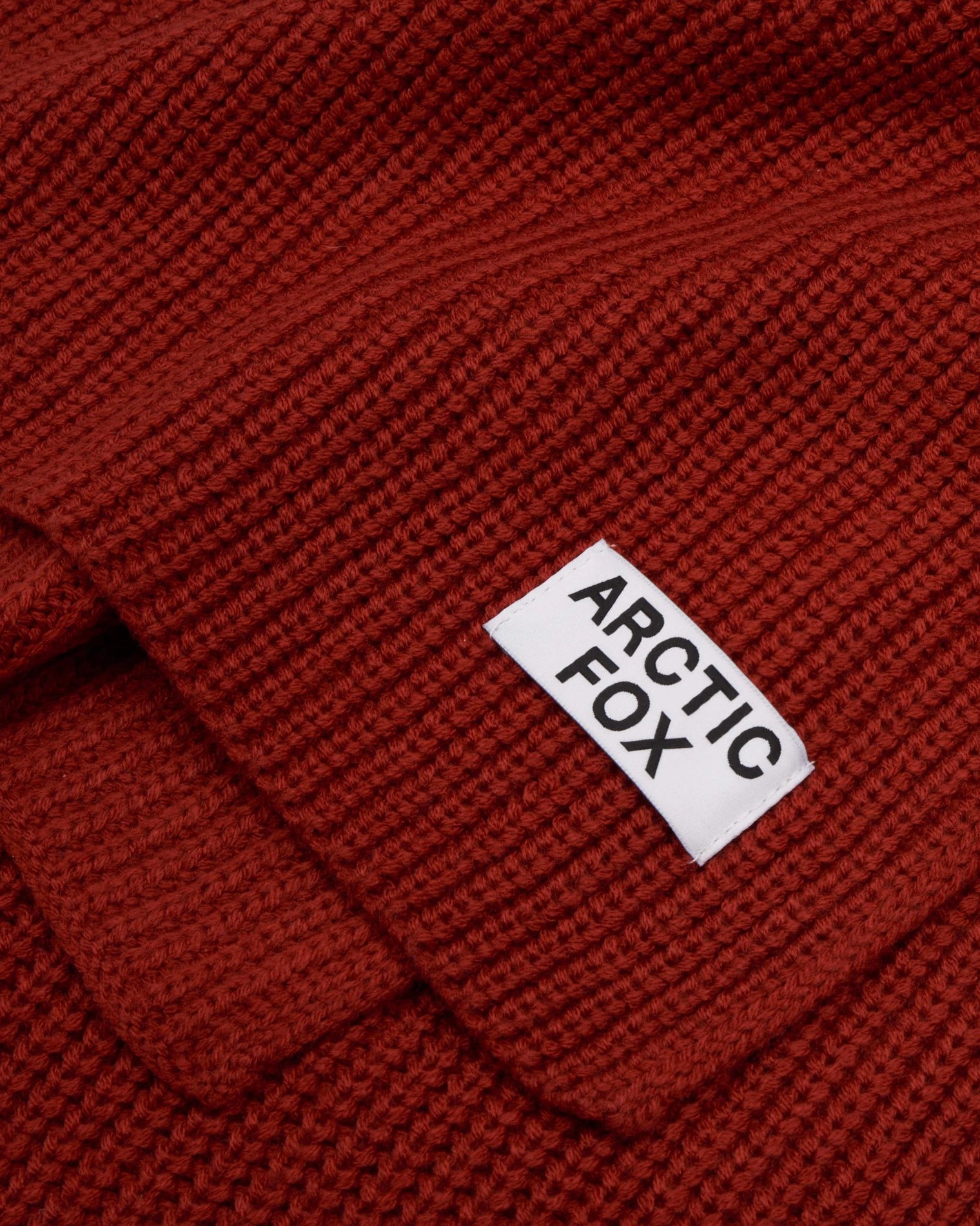 Red knitted fabric with 'Arctic Fox' label, Terracotta Knitted Recycled Bottle Scarf