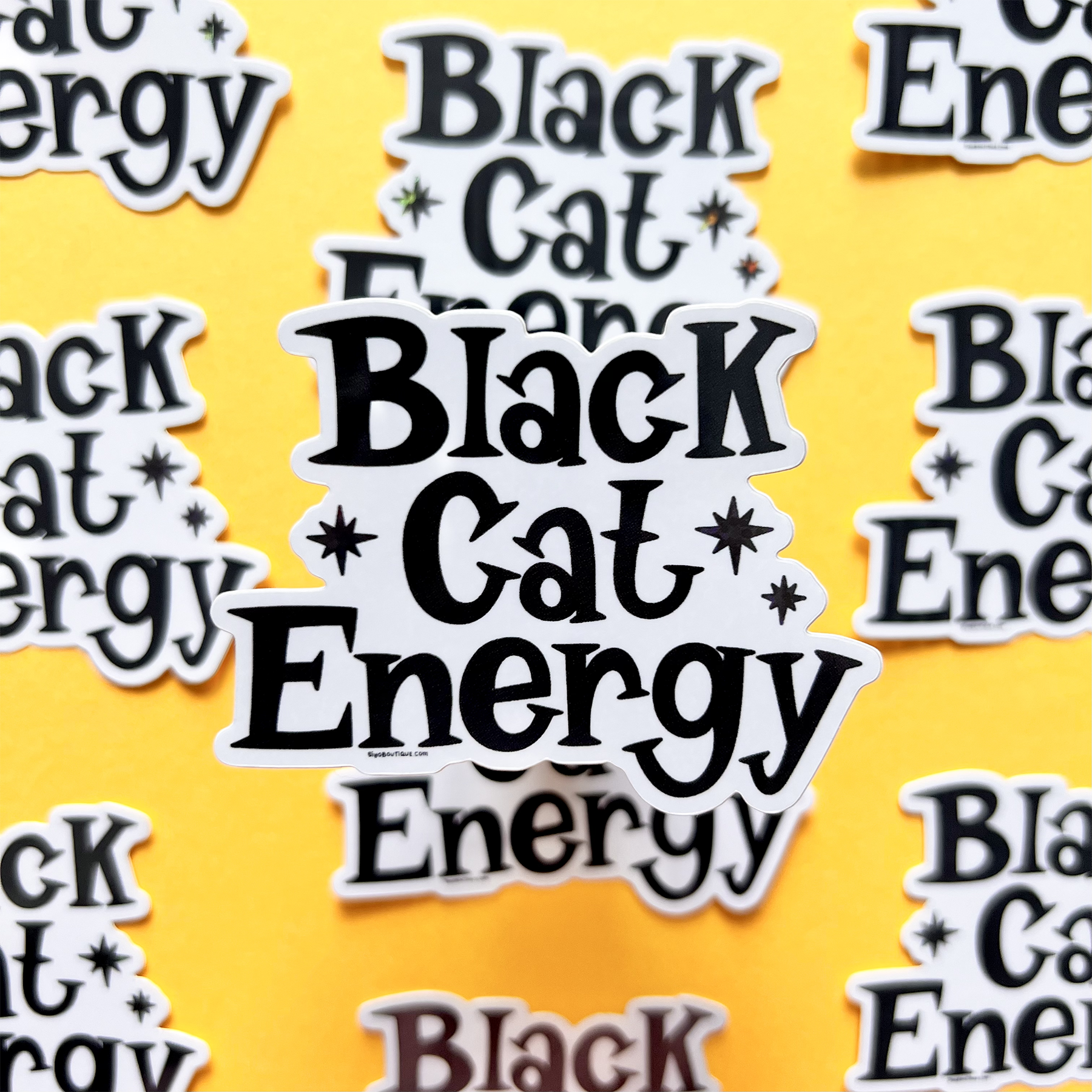 Stickers with 'Black Cat Energy' text on a yellow background