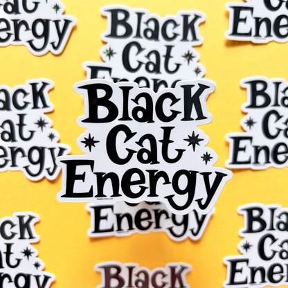 Stickers with 'Black Cat Energy' text on a yellow background