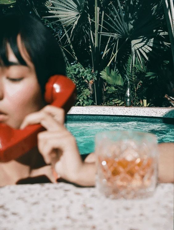 Woman on phone in pool
